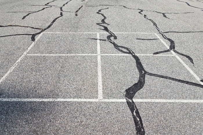 Pavement on playground surface with cracks