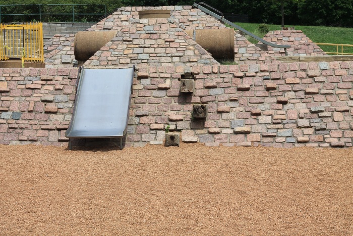 Pea gravel as playground flooring with slide