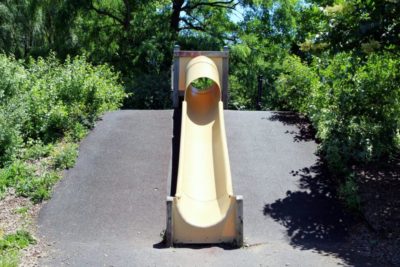 Playground slide with asphalt surface